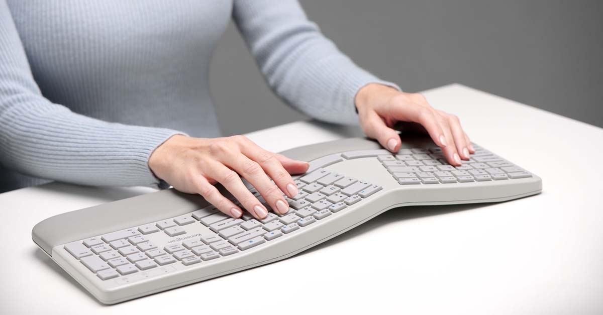 Woman typing on Kensington Pro Fit® Ergo Wireless Keyboard