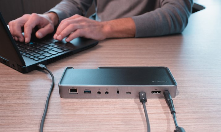 Person using a laptop and docking station 