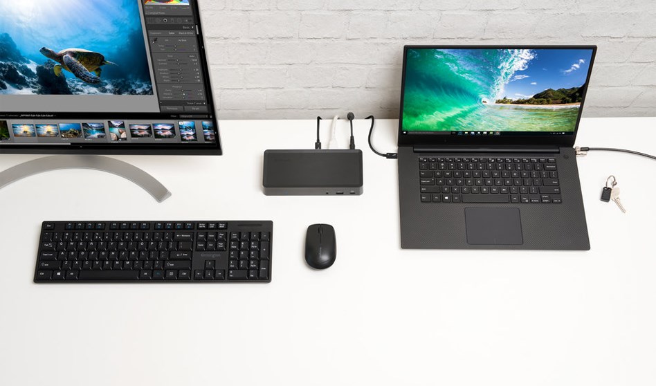 A sekdtop monitor and laptop setup with a docking station and laptop security lock