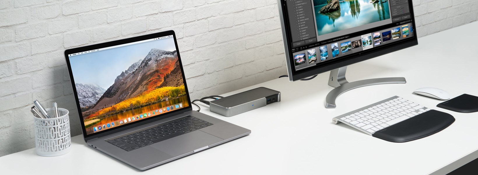 A monitor and a laptop connected to a docking station at a desk