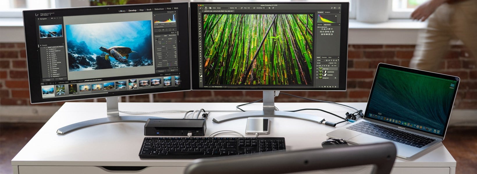 Dual monitors and a laptop connected to a docking station at a desk