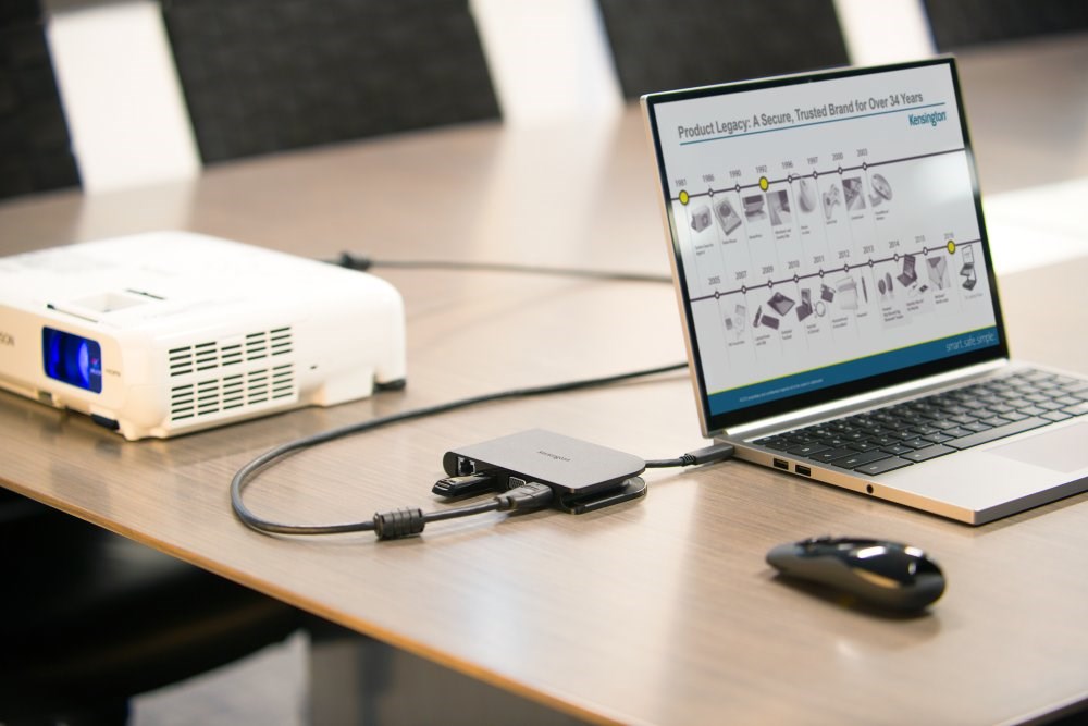 A projector, a flash drive, and a laptop connected with a docking station 