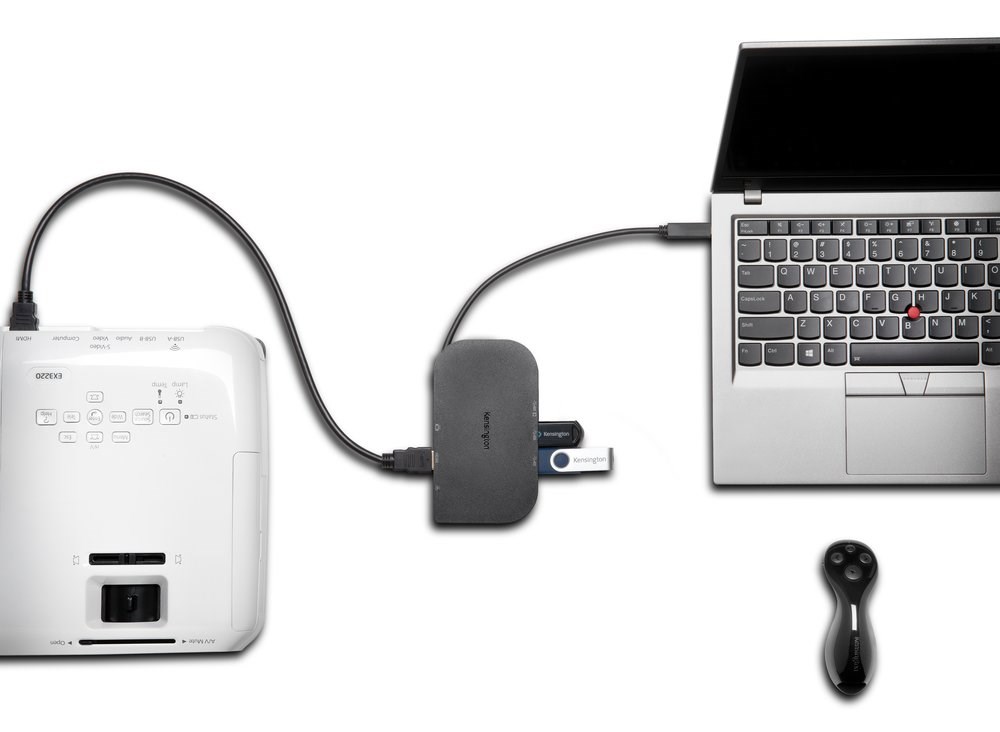 A projector, two flash drives, and a laptop connected with a docking station 