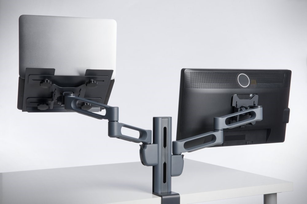 A desktop monitor and a laptop attached to a Kensington monitor arm