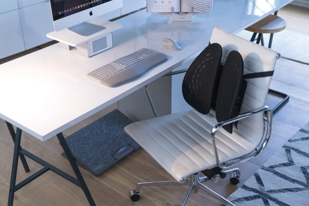 A desk chair at a desk with a SmartFit® Conform™ Back Rest attached