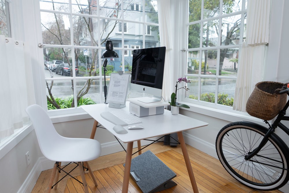 A computer monitor with a monitor stand, wrist rests, and a copy holder