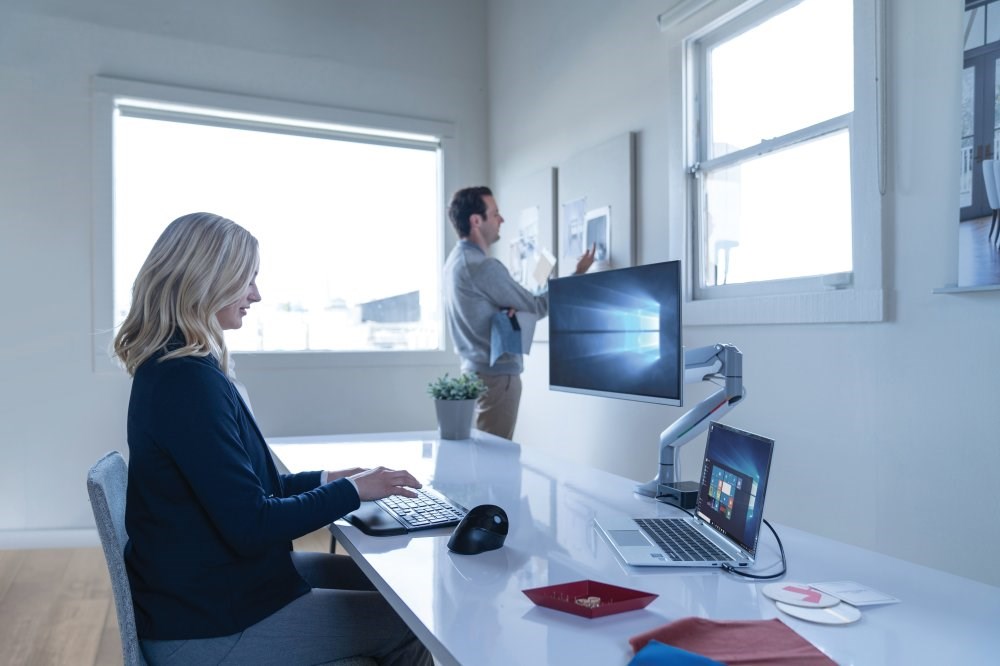 Woman using a Kensington K72344 Slim Type Wireless Keyboard with a vertical mouse