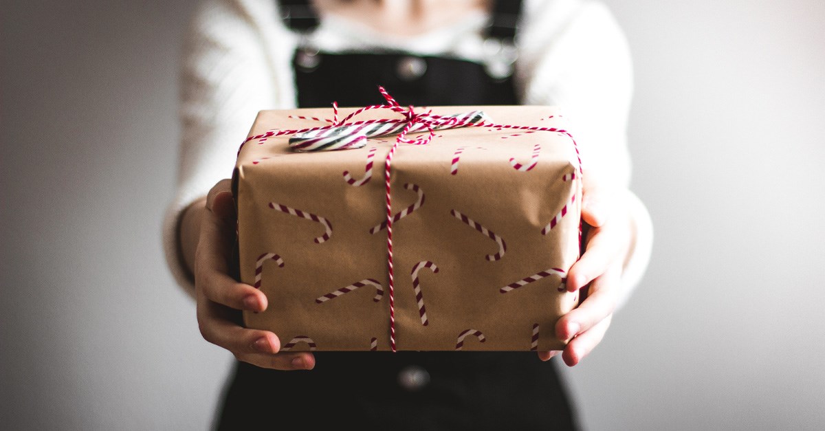 A child handing out a gift