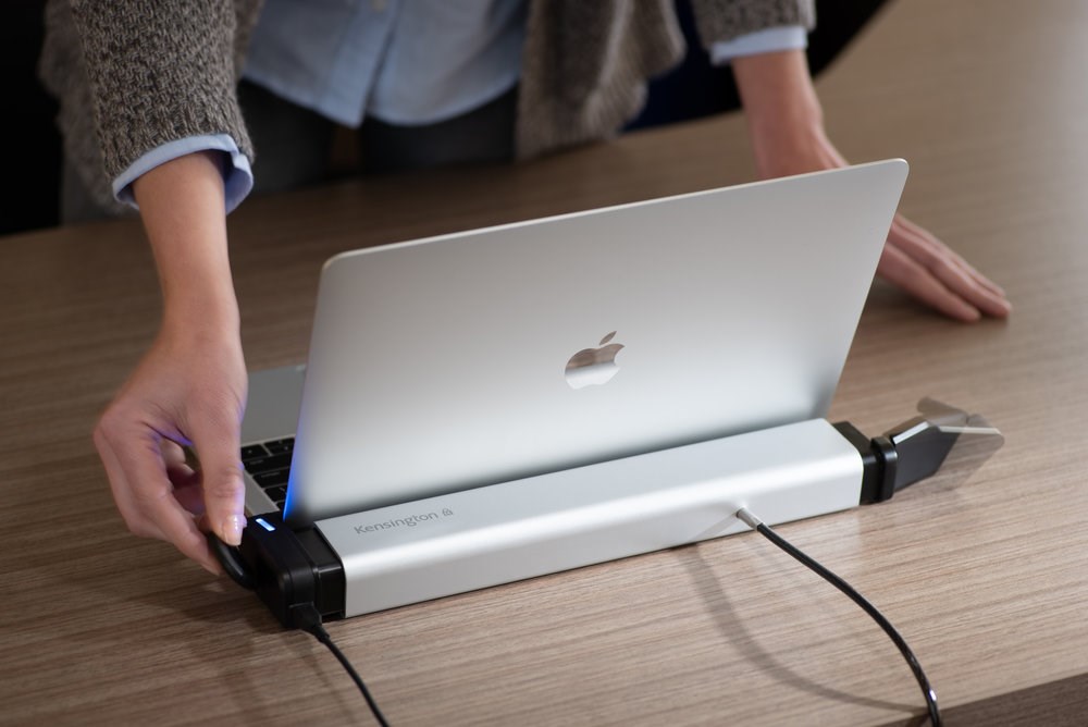 A MacBook laptop connected to a Kensington K-Fob™ Smart Loc