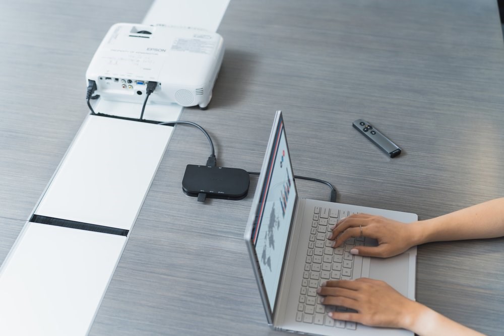 A projector and a laptop connected with a Kensington docking station