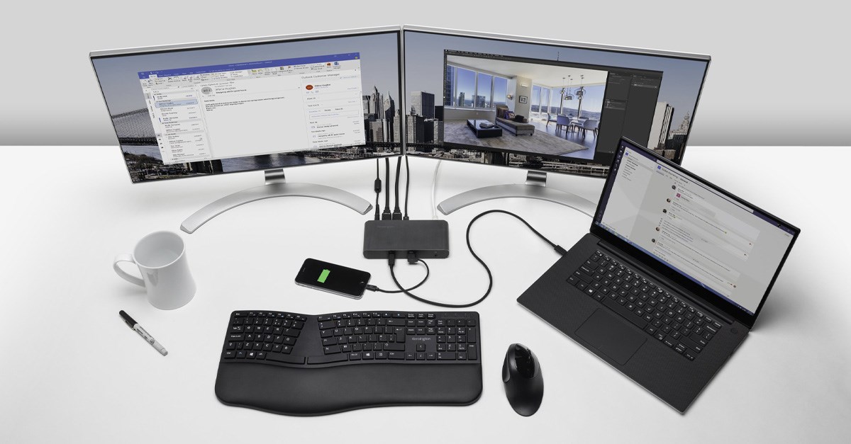 A triple monitor setup and laptop connected to a docking station