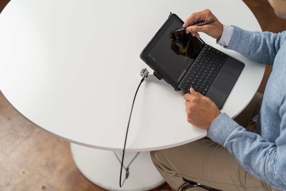 Person using a Surface tablet with a Kensington Surface Lock