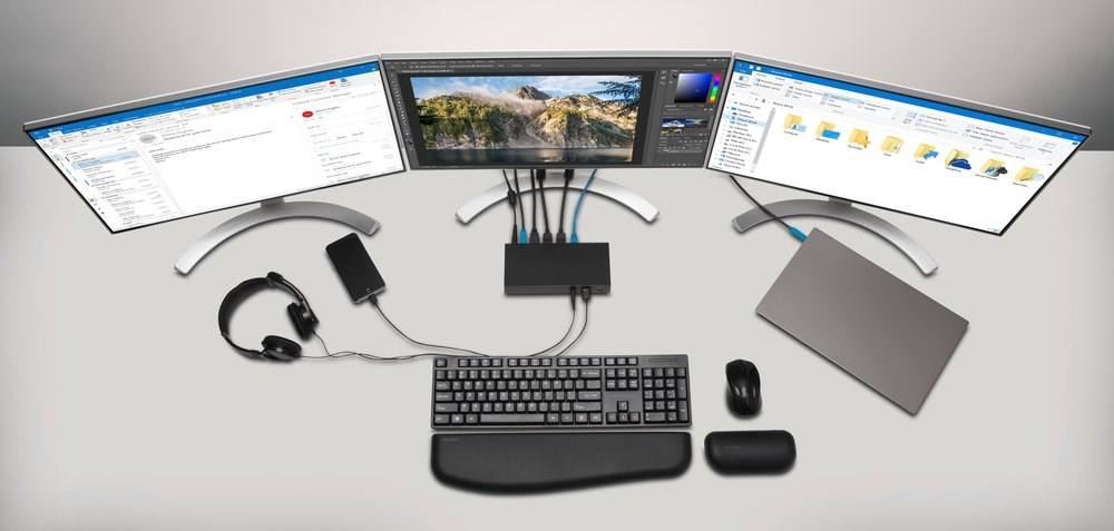 A triple monitor setup and laptop connected to a Kensington Thunderbolt 3-powered docking station 