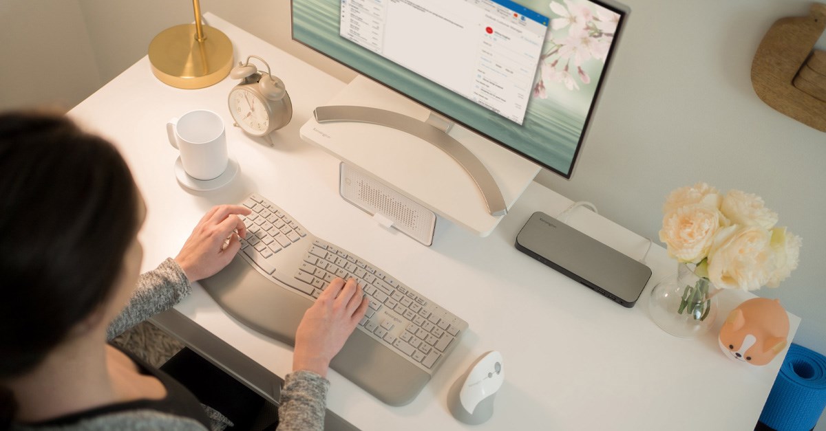 Home office setup with a desktop monitor and a Kensington docking station, keyboard, and mouse