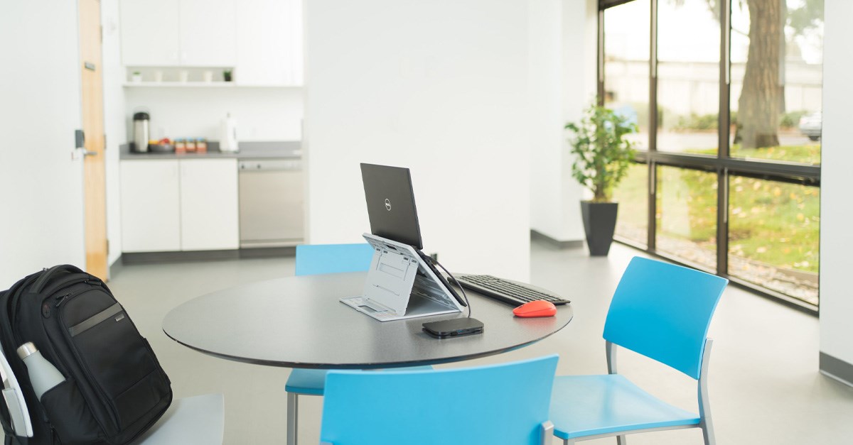 Desk setup with a Kensington laptop riser and laptop backpack