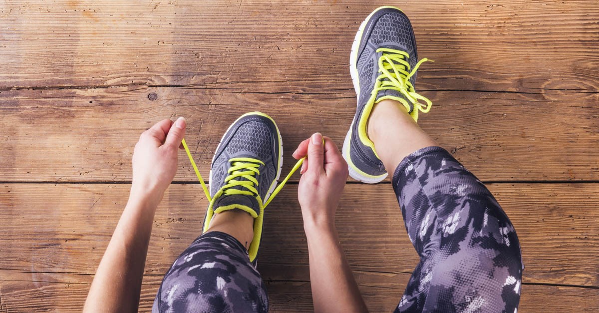 Person tying up laces on their athletic shoes