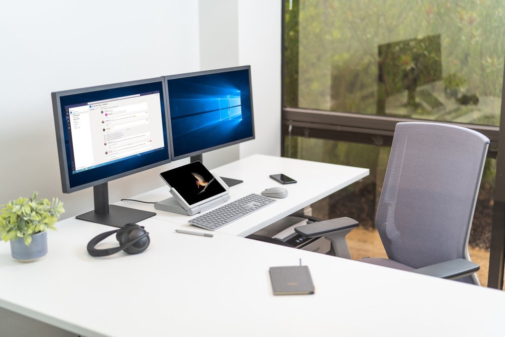 Home office setup with dual monitors and a Kensington tablet riser