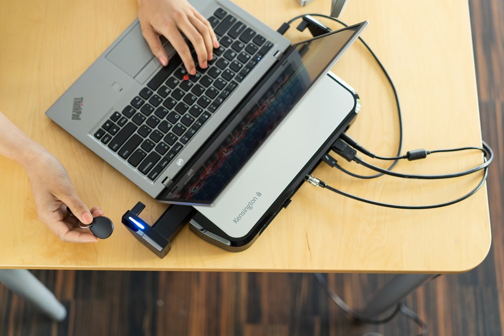 Person using a laptop connected to Kensington’s Thunderbolt 3 Dock with K-Fob™ Smart Lock