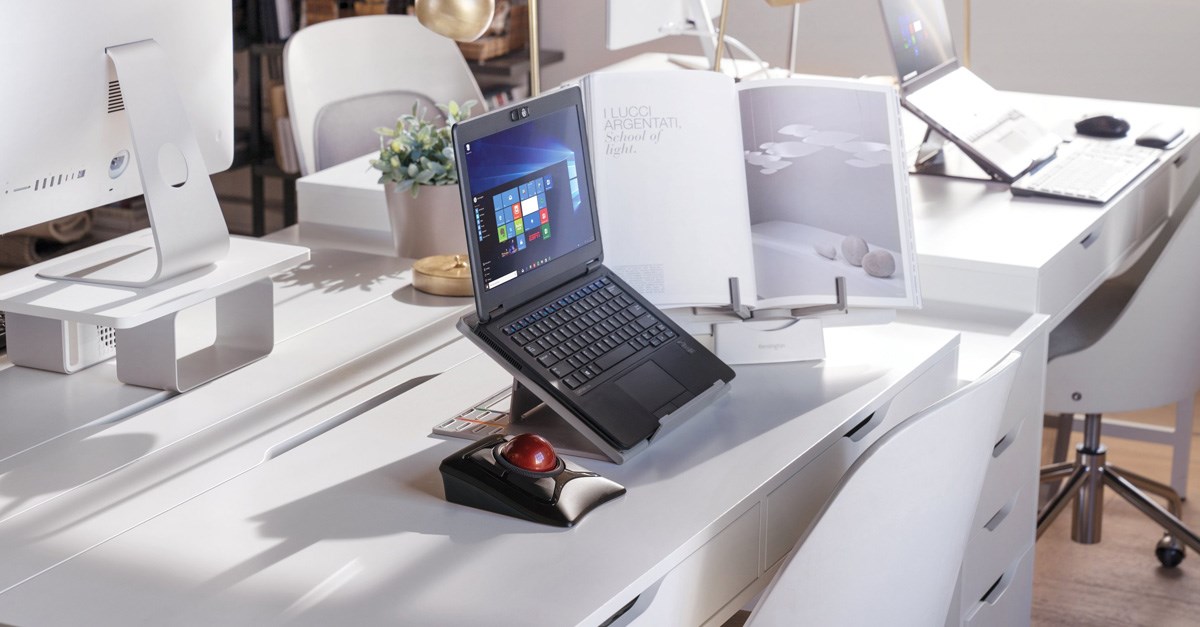 Laptop on a laptop stand and connected to a trackball mouse