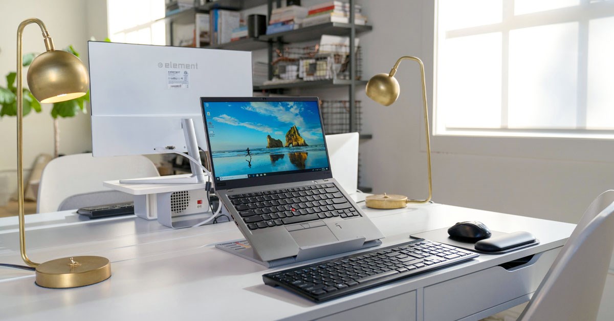 Laptop on top of a Kensington ergonomic laptop riser in a home office