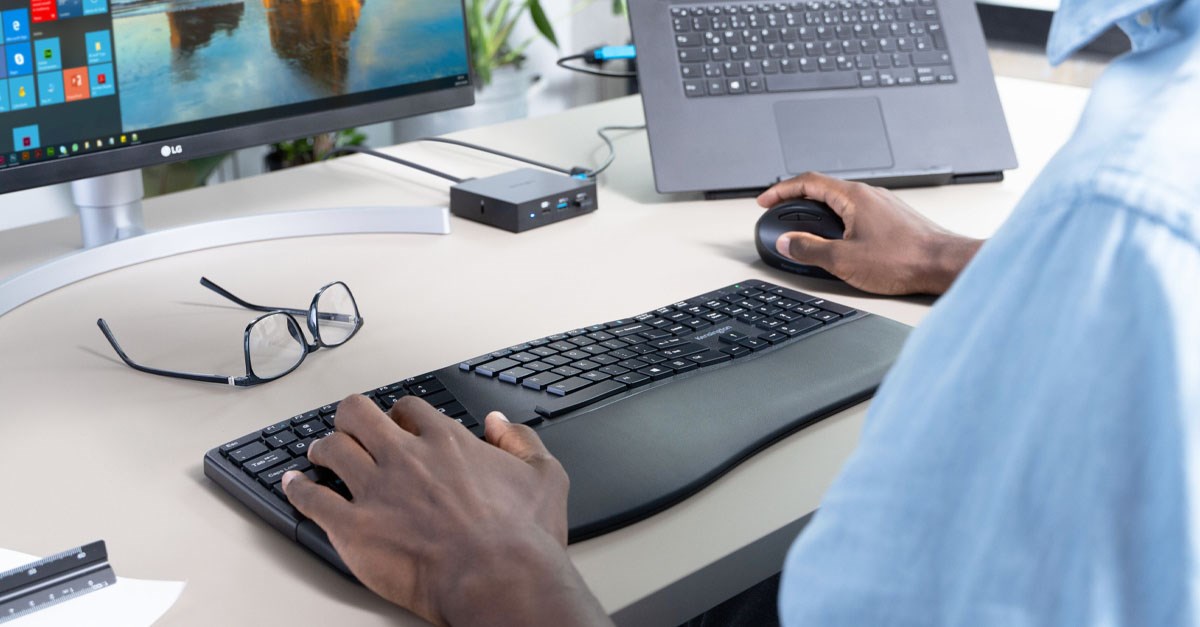 Man at desk with Kensington products