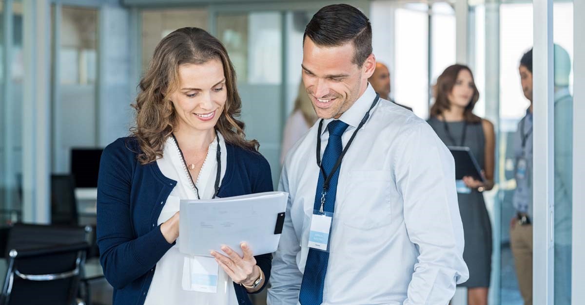 Two people looking at a piece of paper