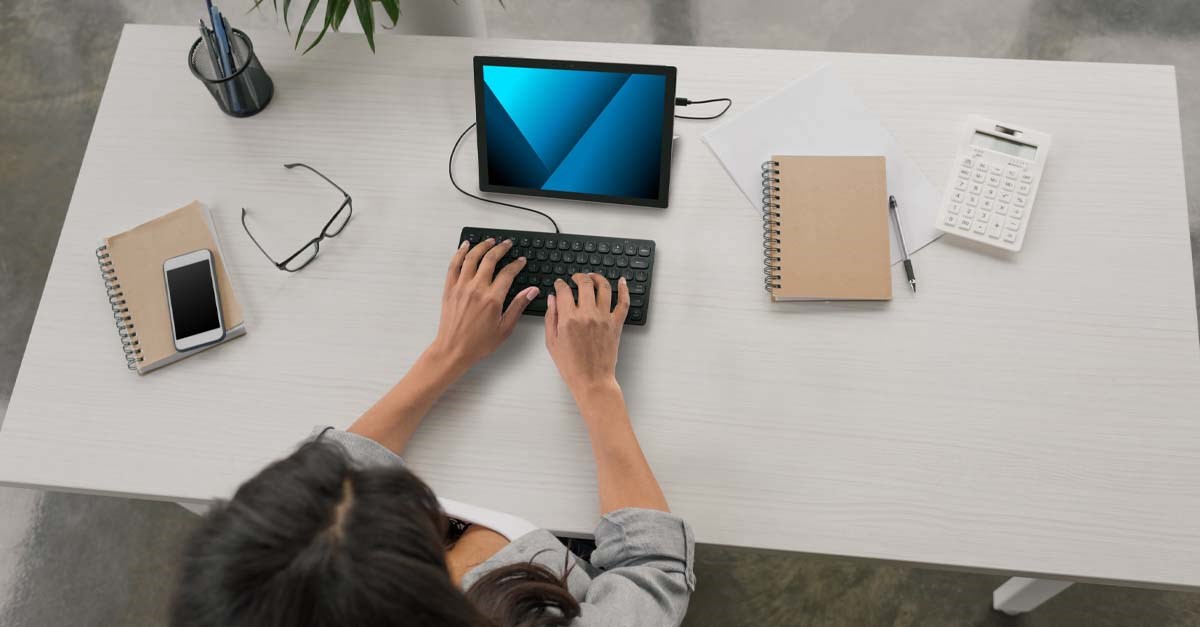 Woman typing on Kensington wired keyboard