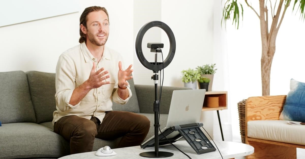 Smiling man sitting in front of the computer having a video conference 