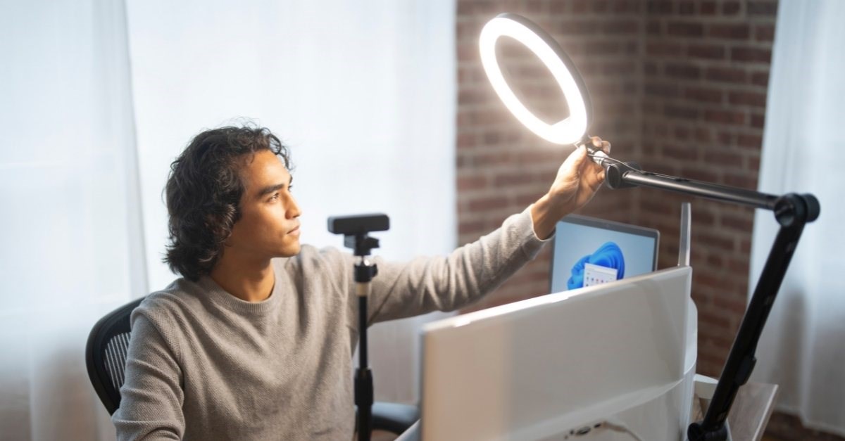 person setting up their ring light to have a video conference 