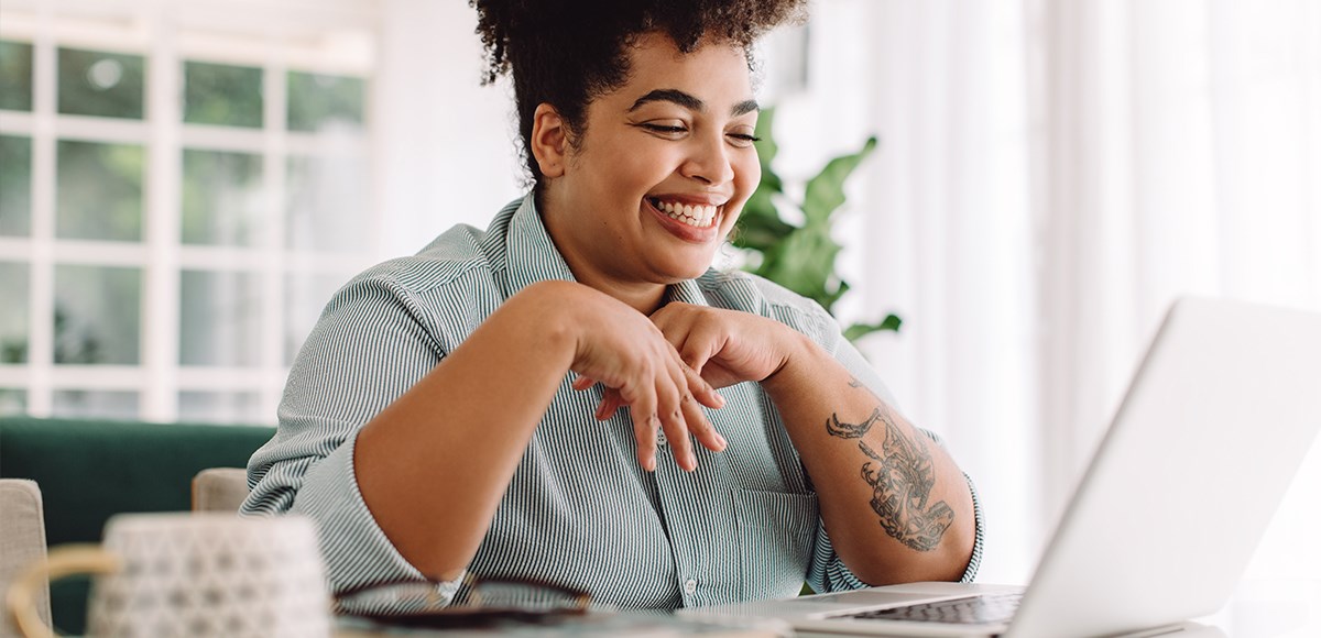 Woman in striped shirt smiling in a videoconference