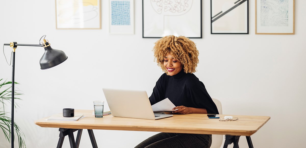 Tidy home workspace with a woman in a video conference 