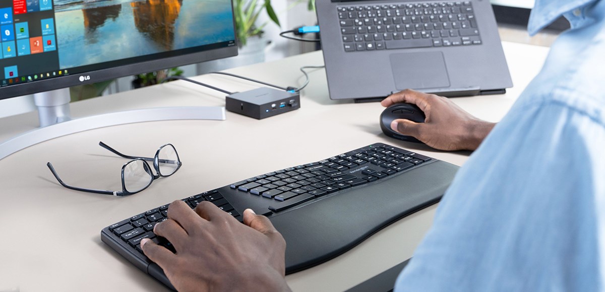 Close-up shot of a desk showing a Kensington Ergonomic Keyboard and Kensington Vertical Mouse 