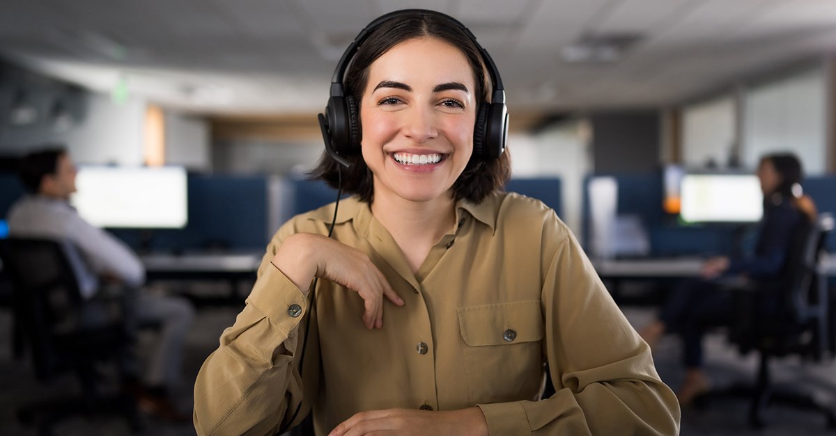 Woman on a work video call using Kensington H1000 headset.