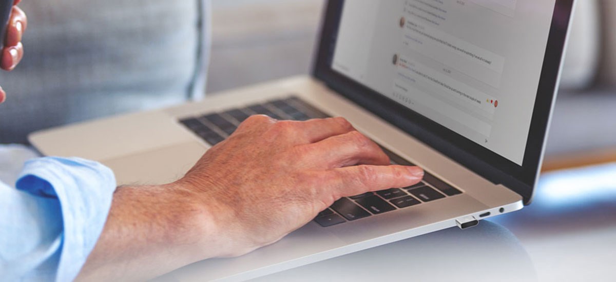 Male's hand working on a laptop with Biometric authentication.