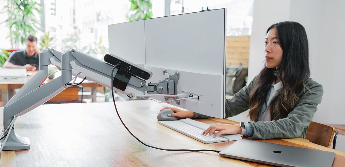 Kensington docking station mounting bracket on a monitor arm showing a clean desk set up.