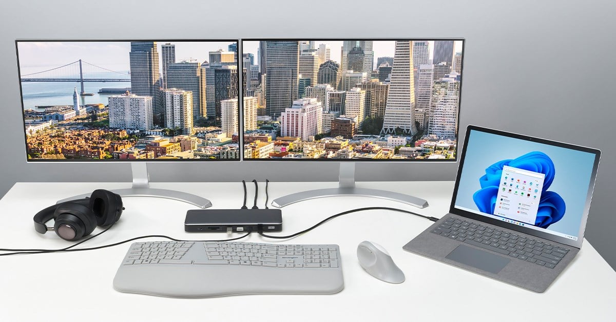 Kensington docking station on a desktop connected to a Surface laptop and two monitors.