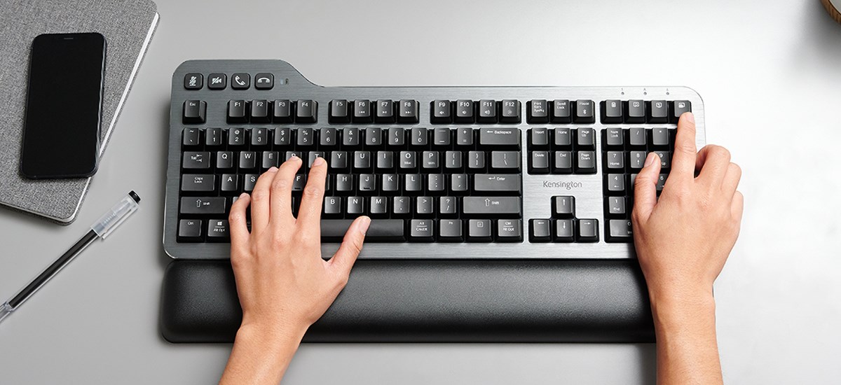 Aerial shot of a desk with Kensington's new quiet mechanical keyboard and wrist rest.