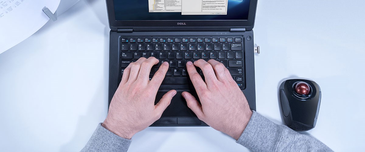 Aerial shot of a laptop with a VeriMark Security Key with a trackball on the side.