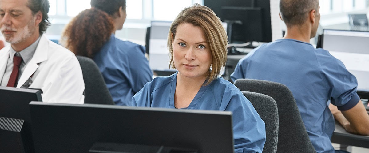 A nurse working on her computer at the hospital.