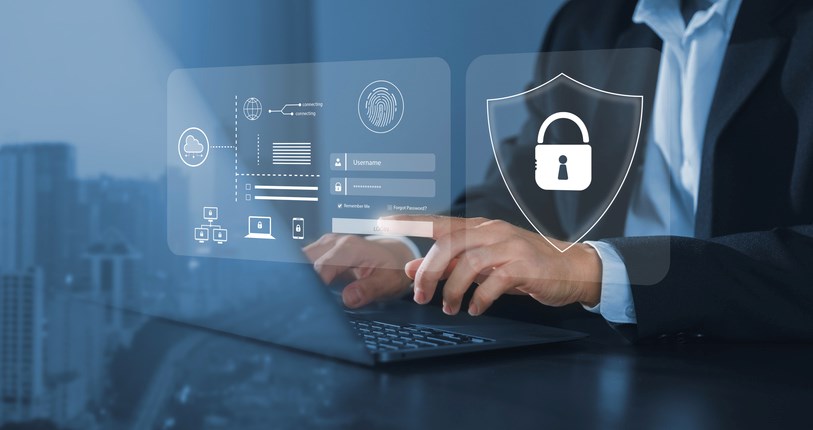 A business person working on their laptop with icons illustrating data protection and security.