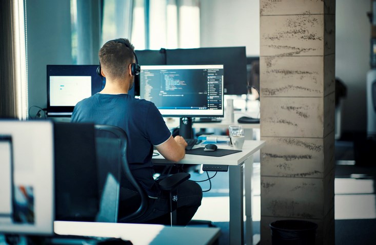 A software engineer working at a co-working space.