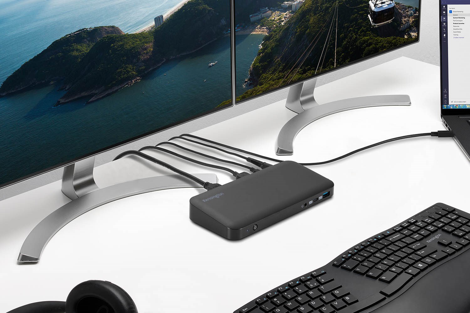 : Dual monitors connected to the SD4845P docking station, alongside a keyboard and laptop on a desk.