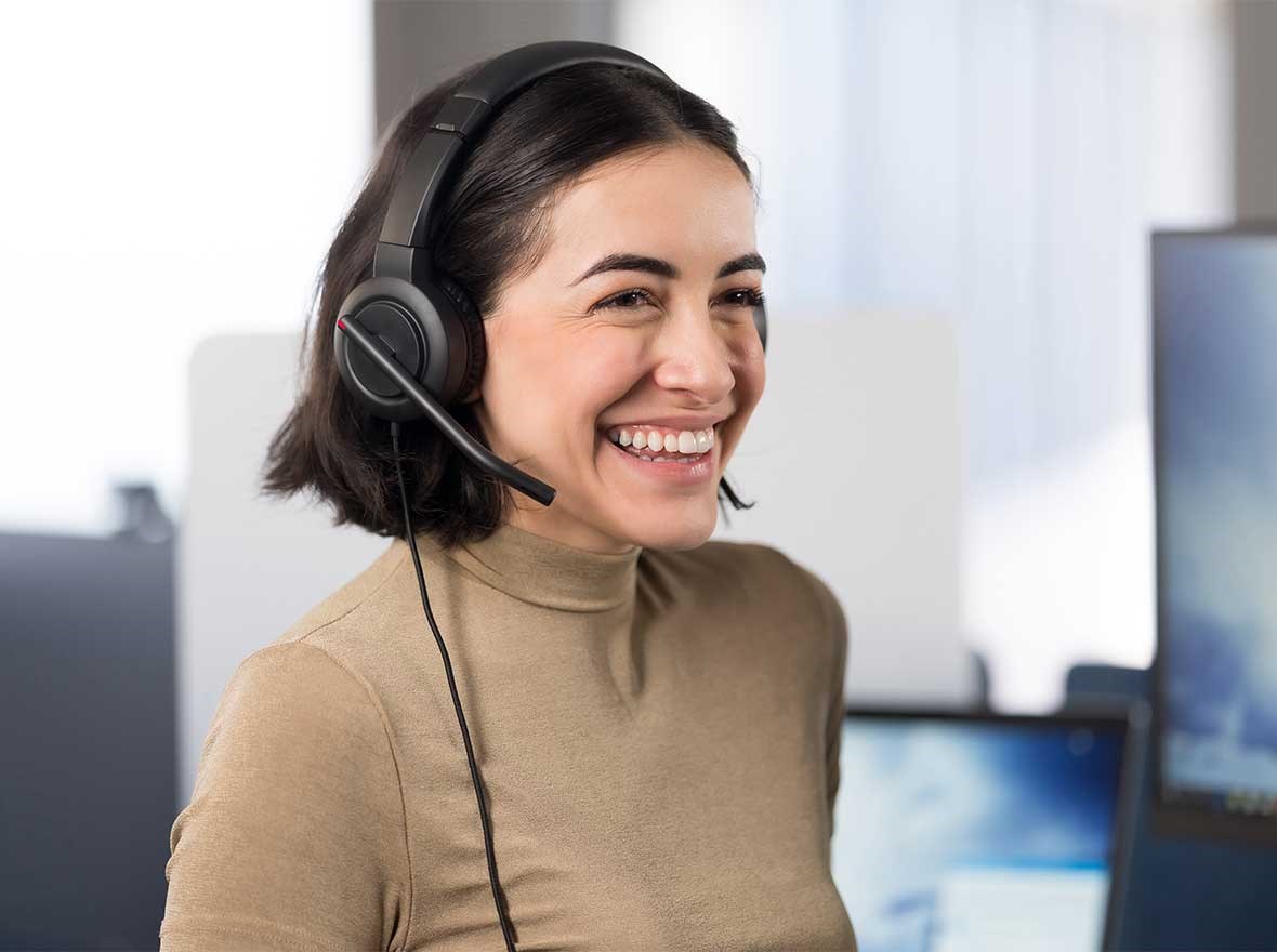 Woman speaking on her headphones.