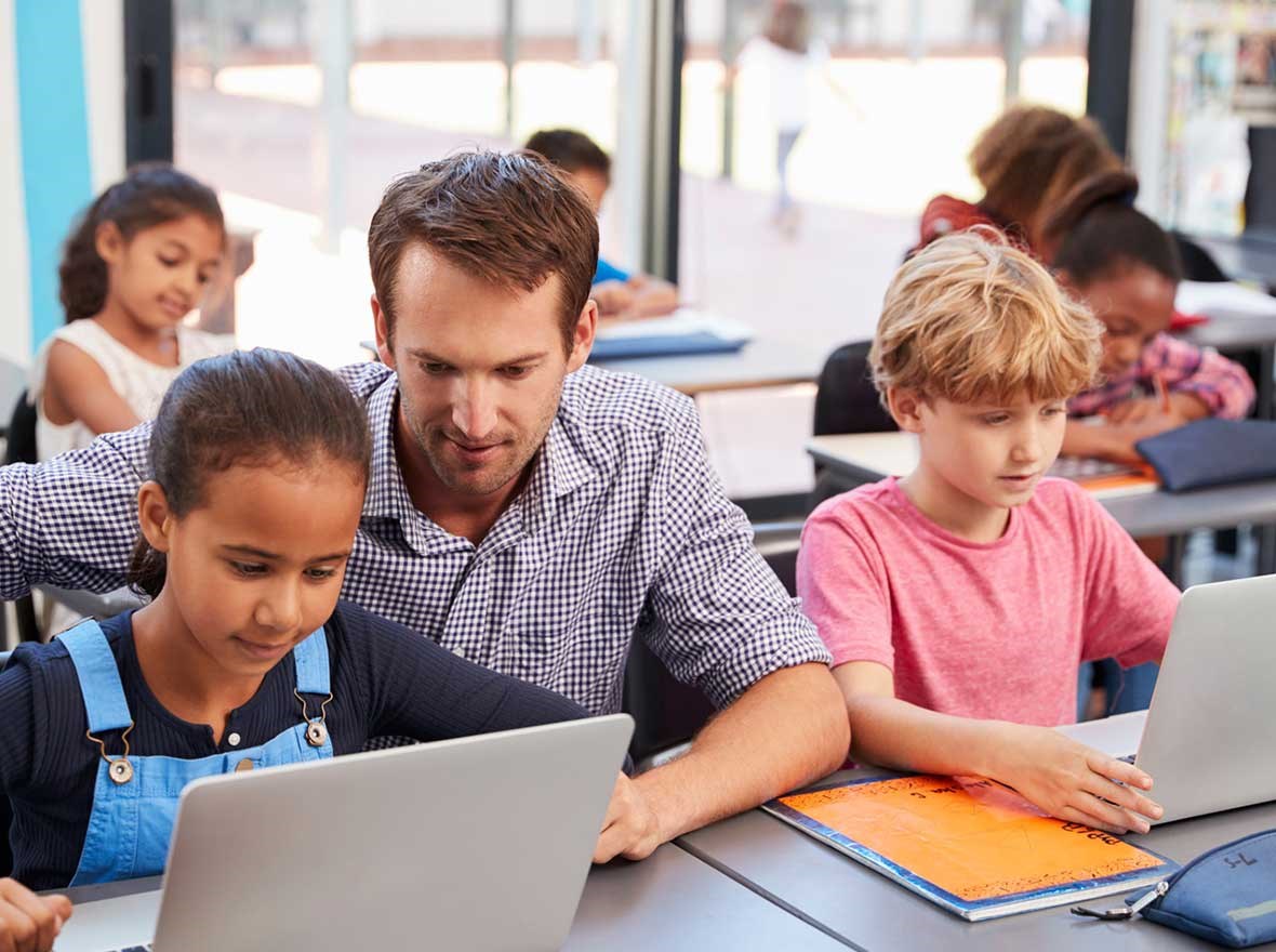 Male teacher teaching 2 kids.