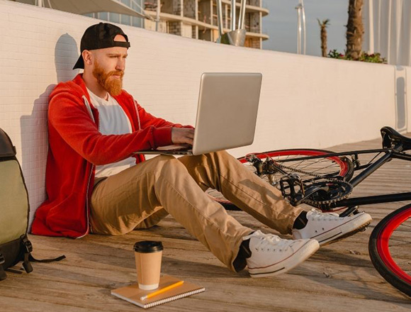 Person working outside on their laptop