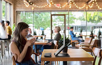 Woman working remotely at cafe