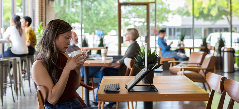 Woman working remotely at cafe