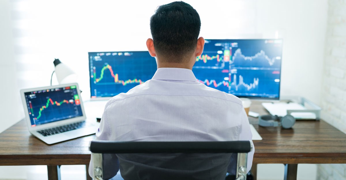 Person looking at multuple computer monitors