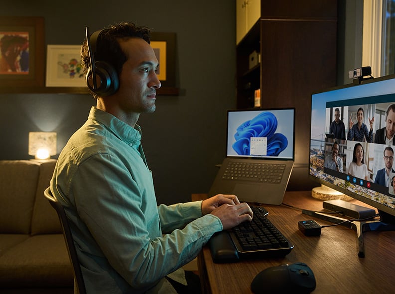 Person typing on MK7500F Silent Mechanical Keyboard at night.