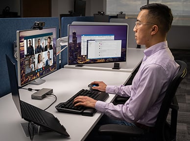 A man at the office typing on MK7500F Silent Mechanical Keyboard.